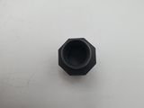an image of a black plastic nut on a white surface