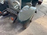 an old car that is parked on the side of the street