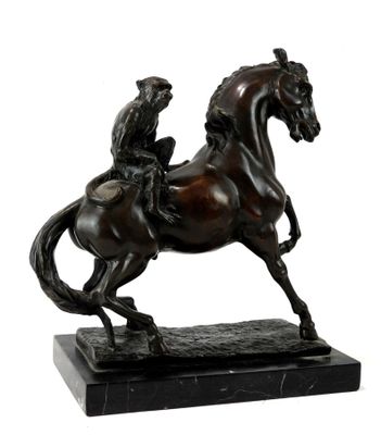 bronze statue of a man riding a horse on a marble base