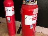 two fire extinguisors sitting next to each other on the floor