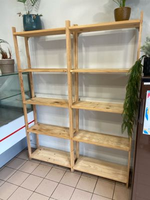 a shelf that has a bunch of plants on it