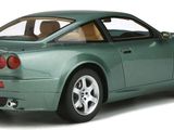 the green sports car is parked on a white surface