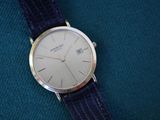 a watch that is sitting on a blue cloth
