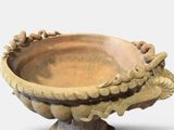 a small bowl that is sitting on a stand