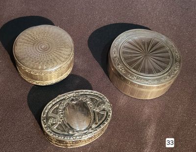 three small metal boxes sitting on top of a table next to each other