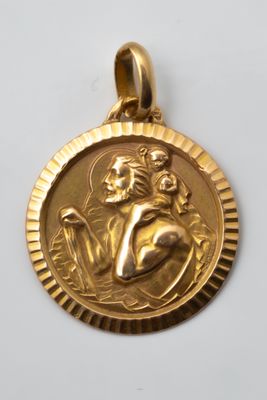 a close up of a gold medal on a white surface