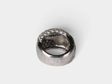 a close up of a diamond ring on a white surface
