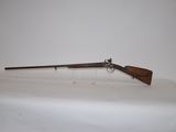 a rifle with a wooden barrel on a white surface