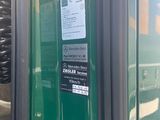 a close up of a green bus with its door open