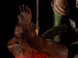statue of a man with a sword and a dog on a fire