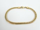 a gold bracelet with a braid design on a white background