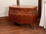 a small chest of drawers in the corner of a room