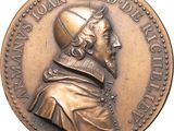an image of a bronze medal of a man with a hat on his head
