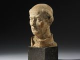 a roman marble bust of a man on a marble base
