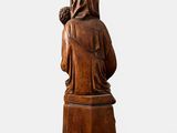 an old wooden statue of a woman with a crown on her head