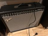 a guitar amp sitting on the floor next to a speaker