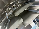 a close up of a metal object on a white surface