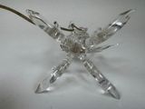 a glass dragonfly that is sitting on top of a table