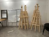 three easels that are standing up in a room