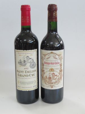 two bottles of wine sitting next to each other on a table