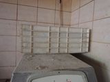 a dirty microwave sitting on top of a dirty counter