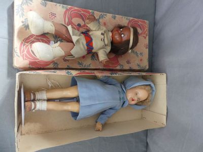 a small doll in a box with a doll in it