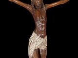 statue of jesus on the cross on a black background