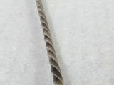 a spoon that is sitting on a white surface