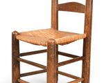 an old wooden chair with a woven seat on a white background