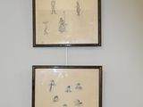 two framed pictures hanging on the wall of a room