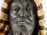 a statue of a man with a hood over his head