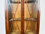 an image of a wooden cabinet with glass doors on top of it