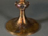 a gold chalicet sitting on top of a table