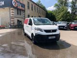 a white van that is parked in front of a building