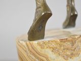 sculpture of a woman ' s foot on a marble base