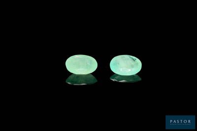 a pair of green jade stone earrings on a black background