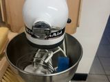 a stand mixer with a bowl and a brush on it