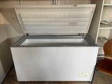 a white chest freezer sitting in the corner of a room