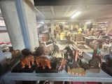 a lot of toys that are on a shelf in a room