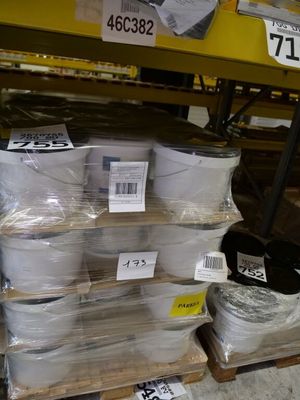 boxes of toilet paper are stacked on a pallet in a store