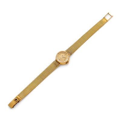 a gold wrist watch with a mesh band