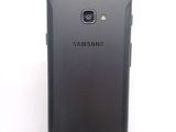 the back of a black samsung galaxy s4 phone with a white background