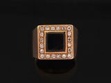 a gold ring with a black stone surrounded by white diamonds