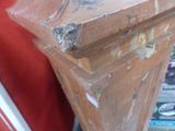 a brown piece of furniture that is sitting on top of a table