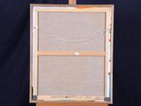 an easel with a piece of fabric on top of it on a black background