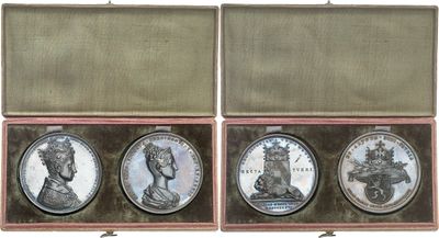 three silver coins in a wooden case with a white background