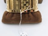 a close up of a gold bracelet with a price tag on it