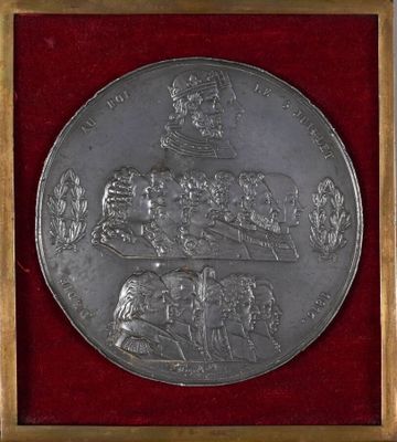 a close up of a silver medal with a picture of a man on a horse