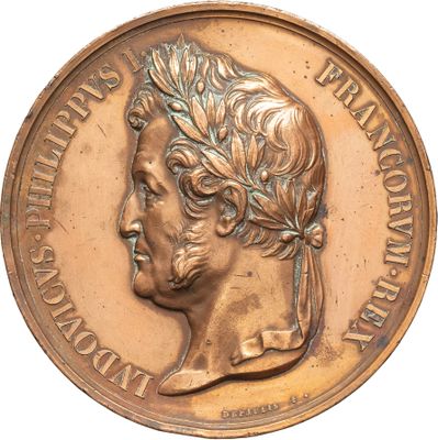 an image of a bronze medal with a woman ' s head on it