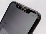 a broken glass screen on the back of a cell phone